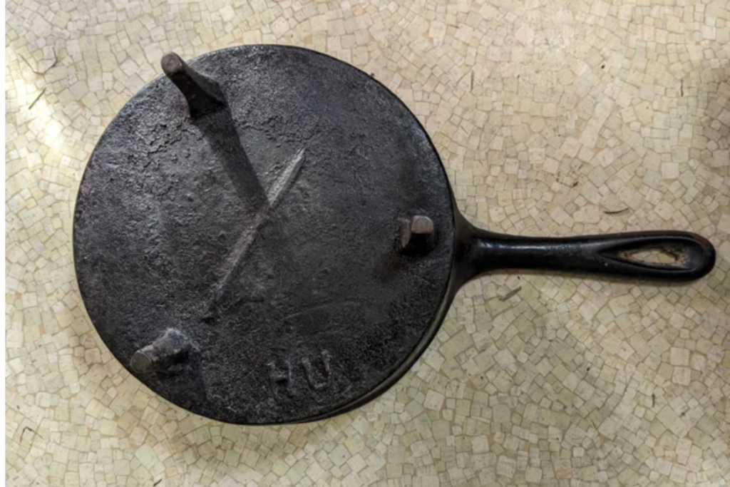 Spider three-legged cast iron skillet