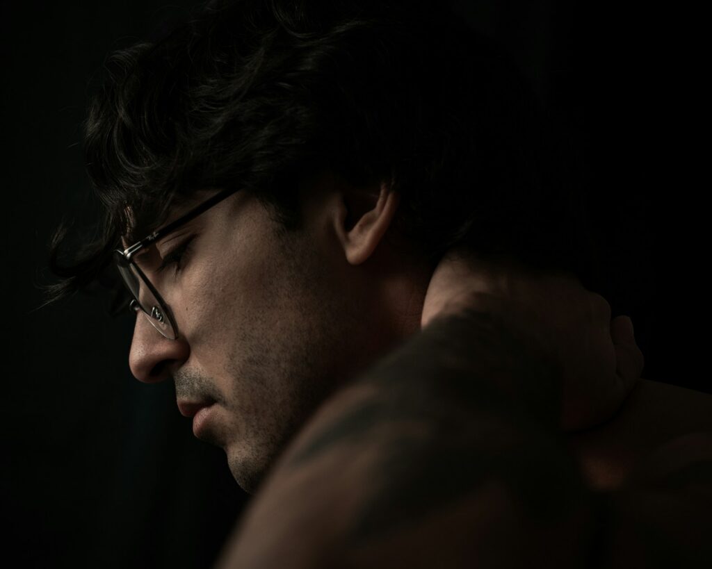 a man with glasses and no shirt on