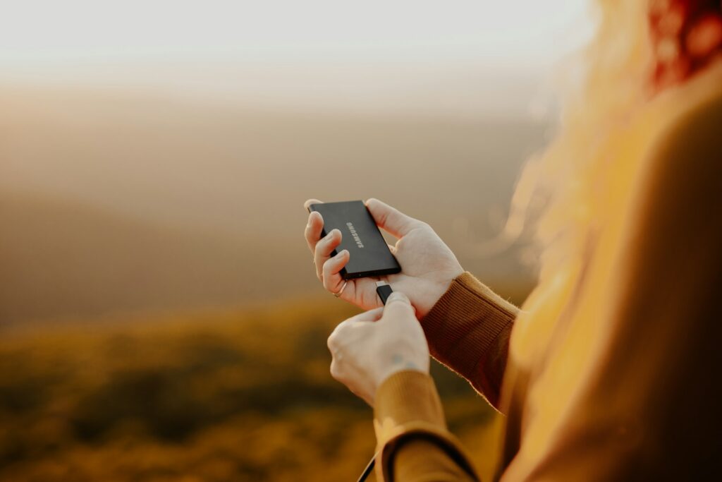person holding black smartphone during daytime