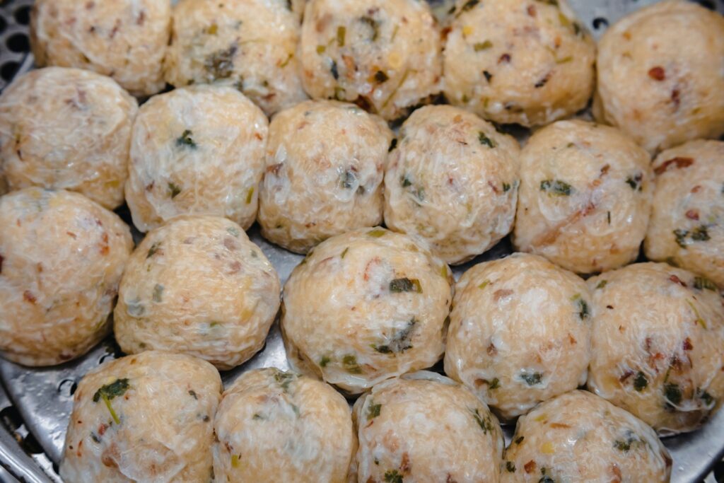 a bunch of balls of food sitting on top of a grill