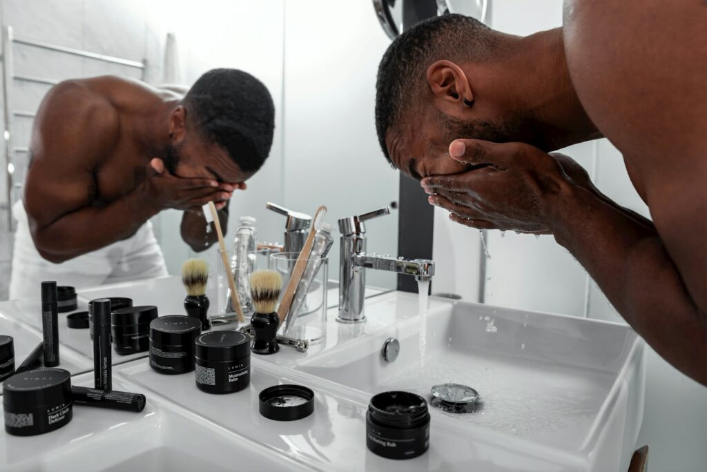 Man washing face before shaving at the sink