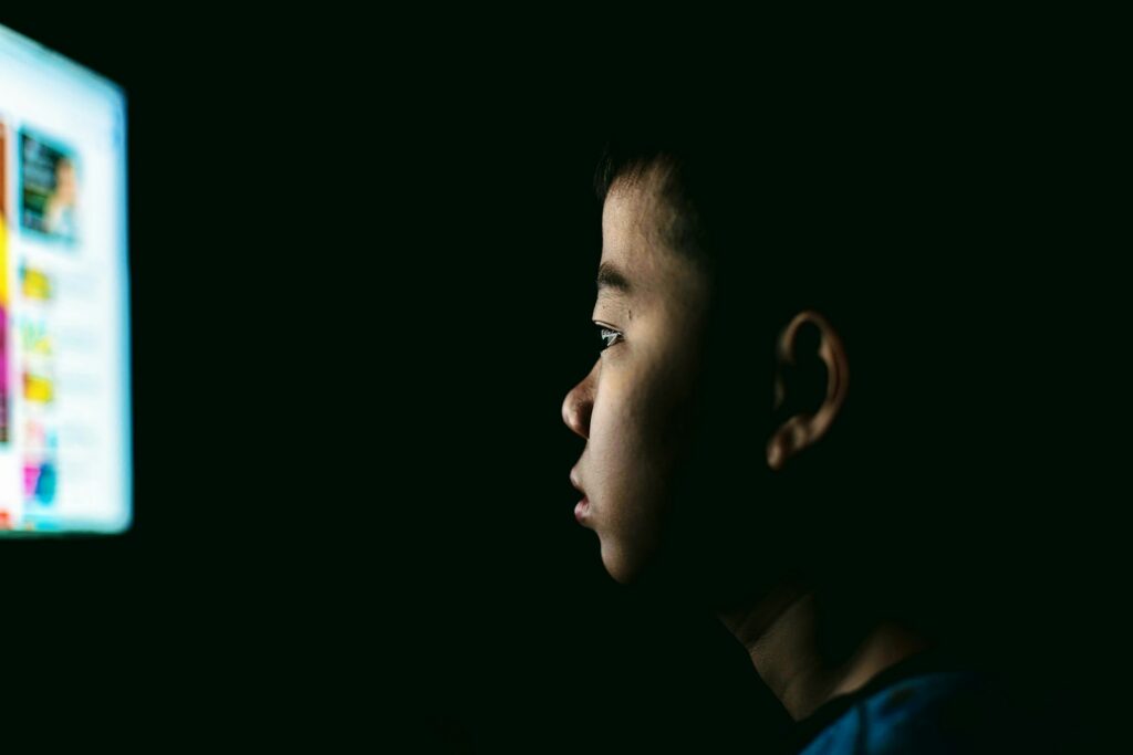 boy watching in front of a monitor