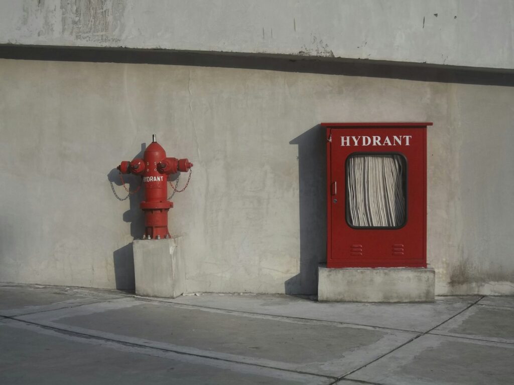 Fire hydrant and a red emergency hydrant box.