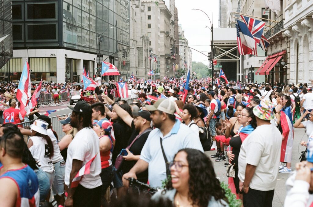 Crowd with flags celebrating on a city street