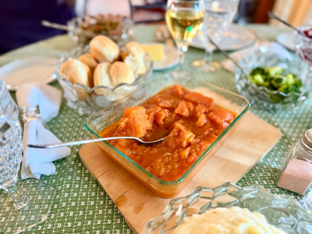 A thanksgiving dinner table with various dishes.