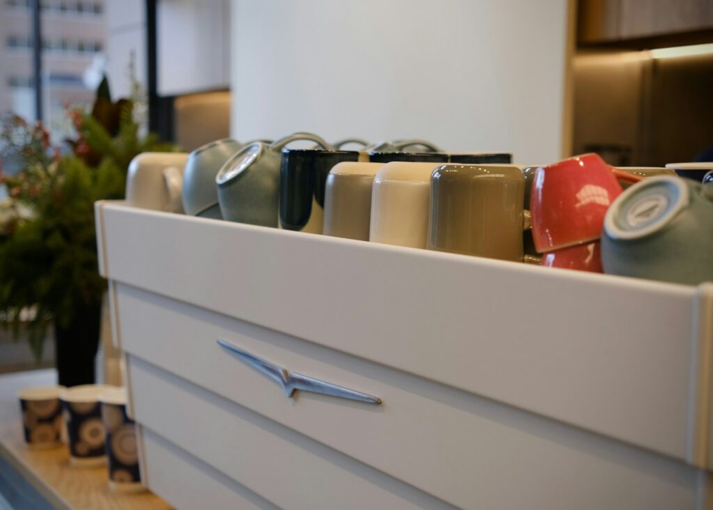 Row of upside down coffee cups on cabinet