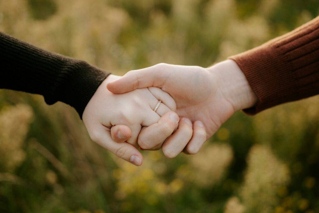 Two hands holding each other with a ring