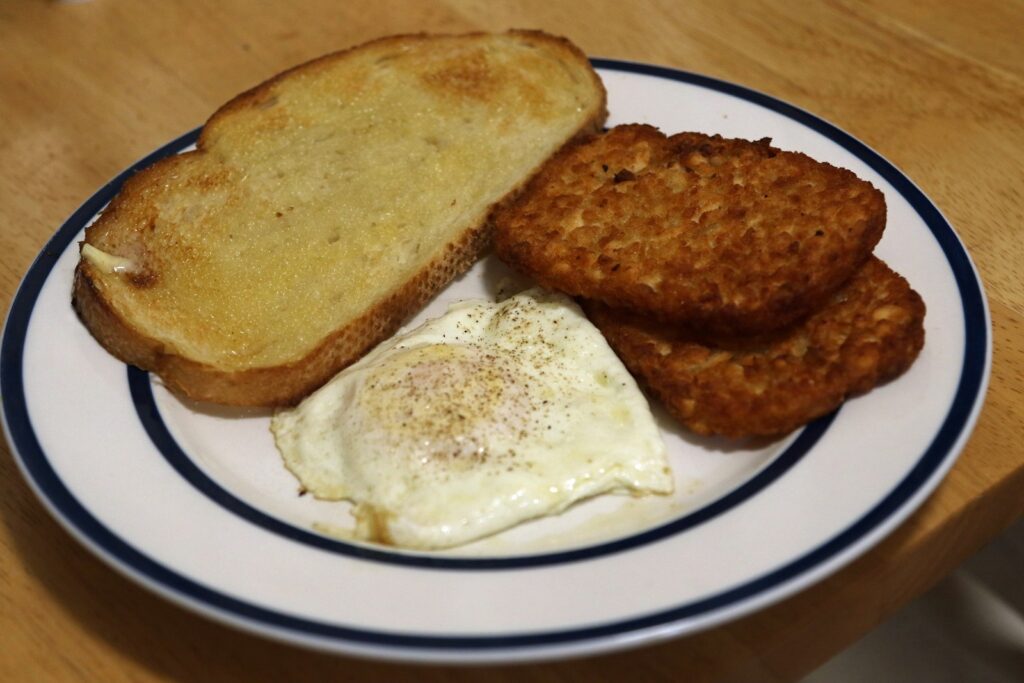 a white plate topped with fried eggs and toast