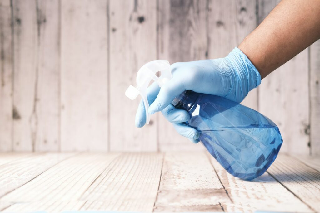 Person spraying a homemade cleaning solution