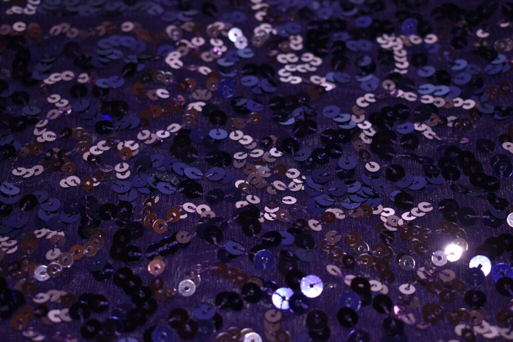 a close up of a purple sequinized surface