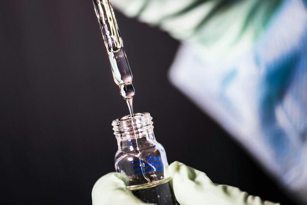 Researcher holding an expensive biological medicine vial