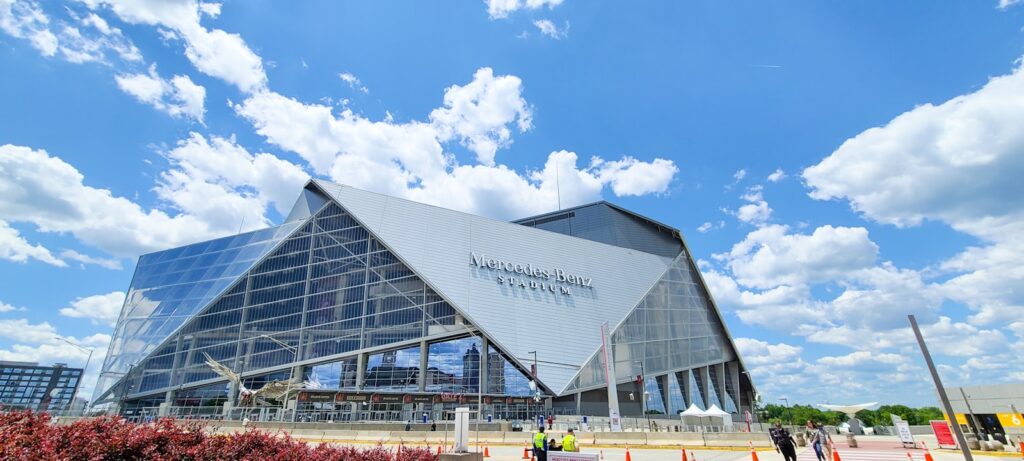 a large glass building with a sky background