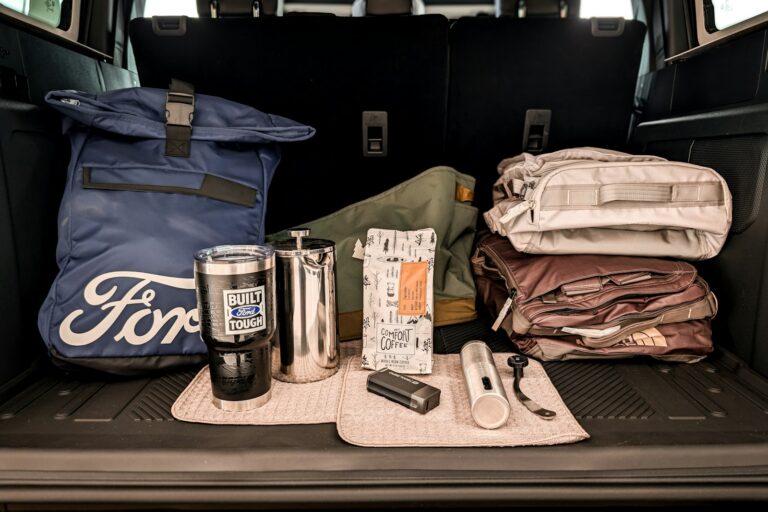 Ford branded bag and travel accessories in car trunk