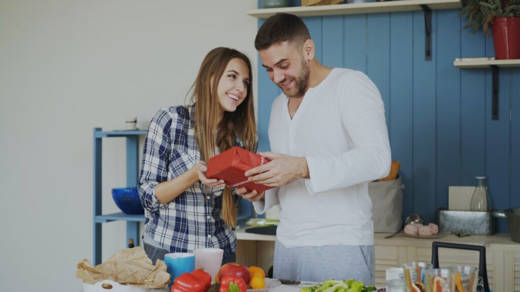 Couple looking at a red heart shaped object