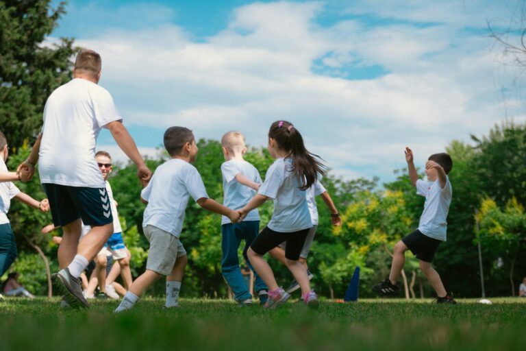 a group of children and adults playing a game of frisbee