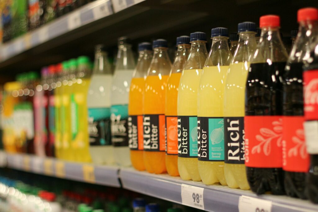 A row of bottles of juice on a store shelf
