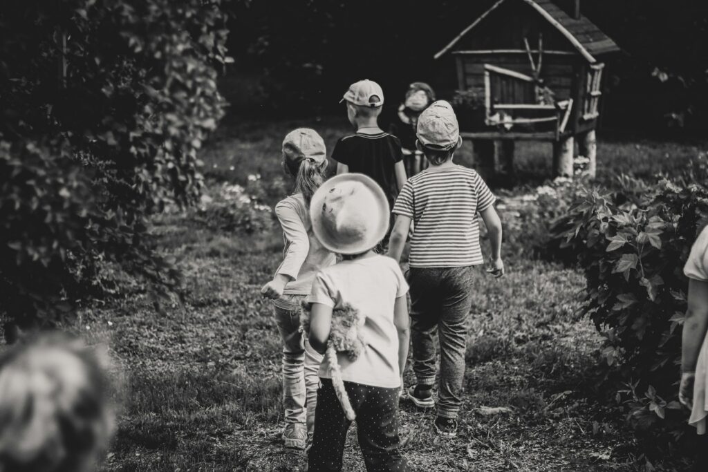 grayscale photo of pioneer children outdoors