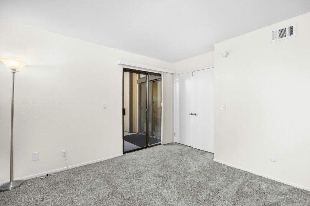 An empty room with a door and a light