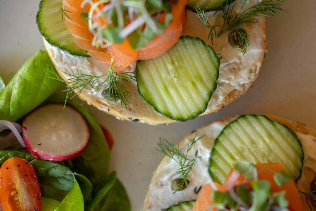 A close up of a plate of sandwiches with cucumbers