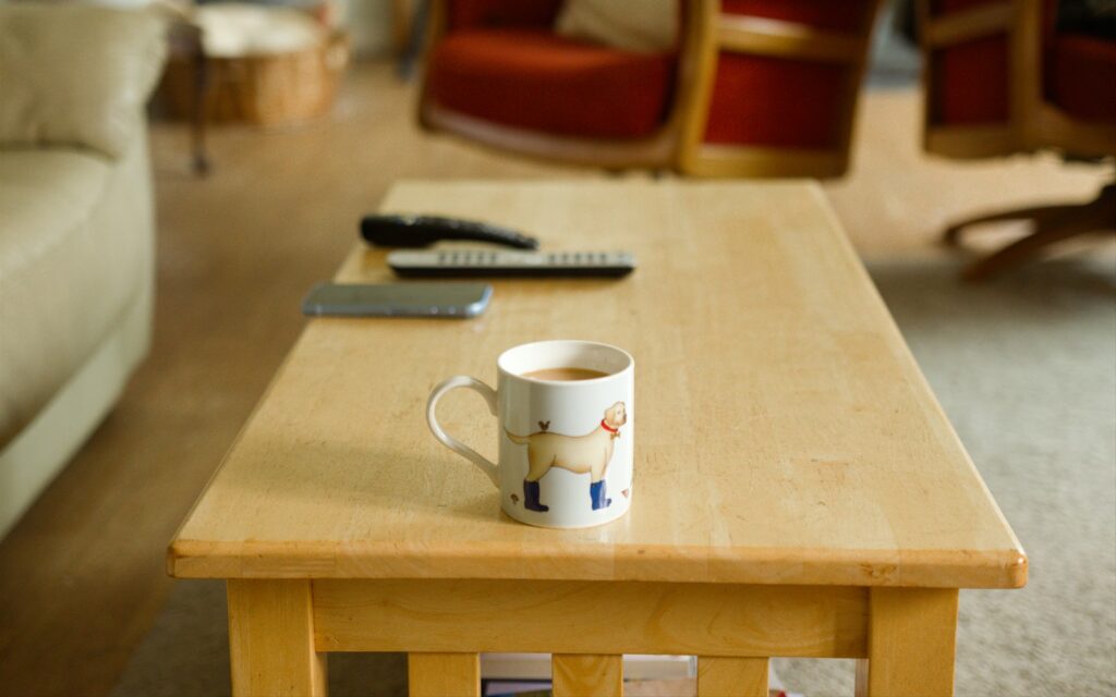 A coffee table with a cup of coffee on it