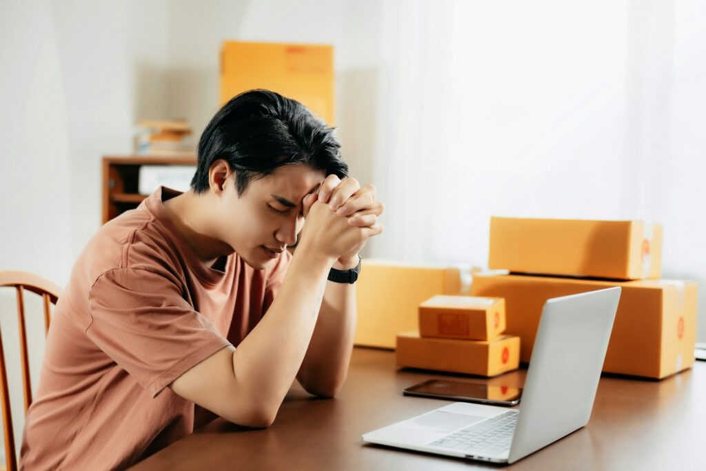 A man sitting in front of a laptop computer