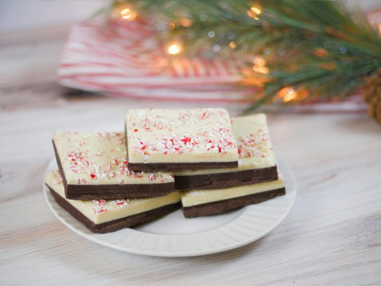 a white plate topped with brownies covered in white frosting