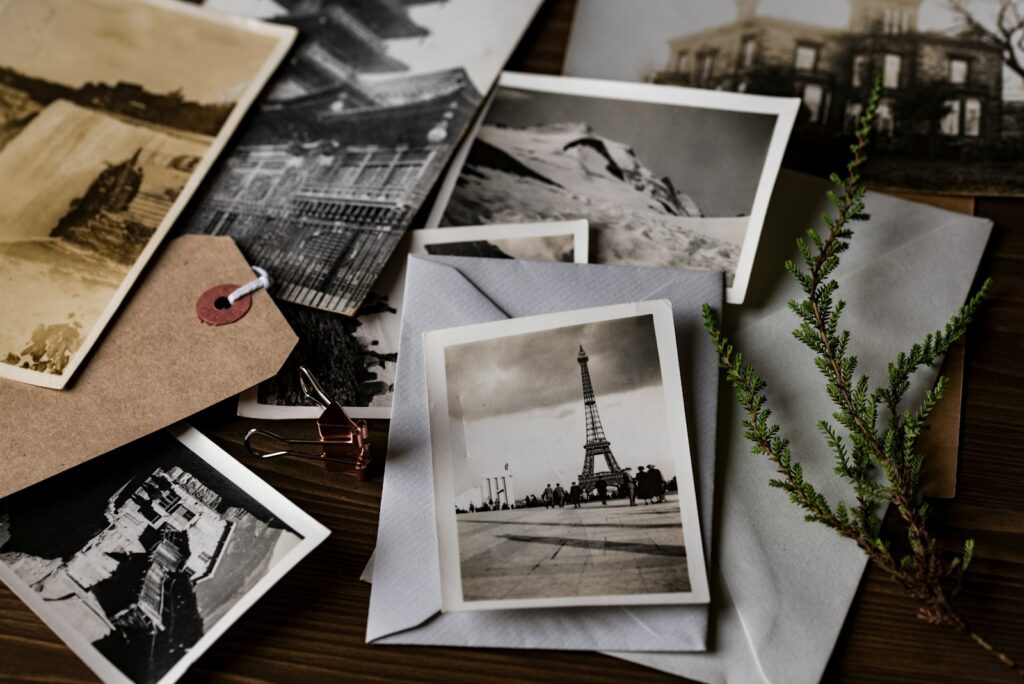 grayscale photo of Eiffel tower postcard on top of white envelope