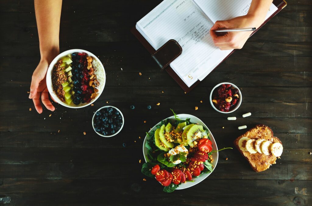 Person meal planning with snacks and salad