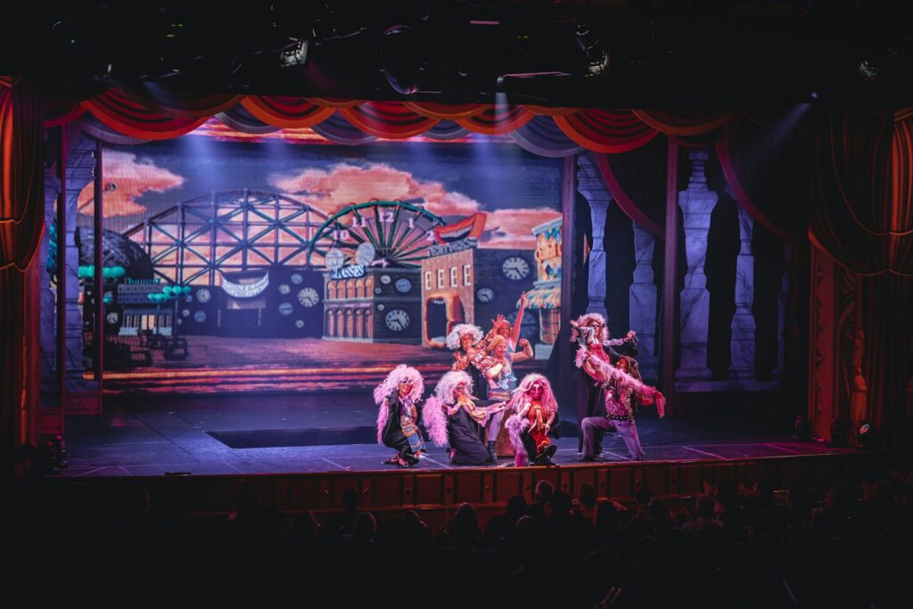crowd of people watching a stage performance in the theater