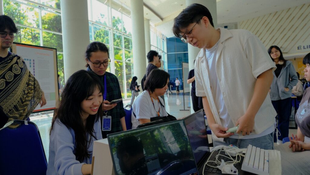 Group of young people engaging with technology indoors.