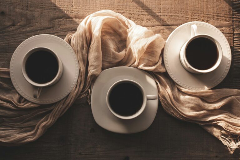 three cups of coffee are sitting on a table