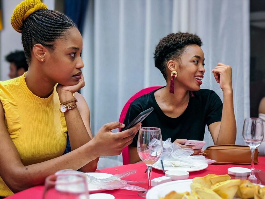 Two girl friends sitting at table during a meal together