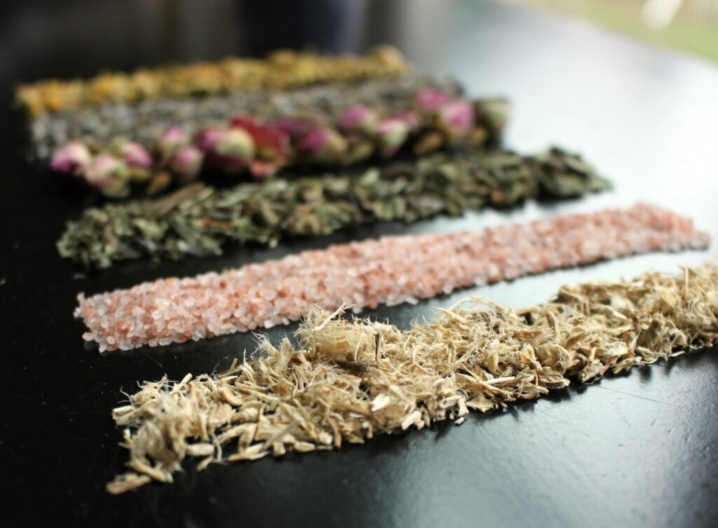 Dried herbs and flowers are arranged on a table.