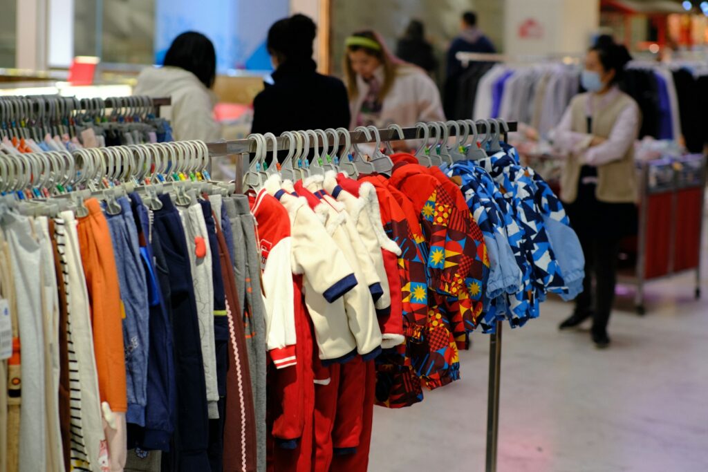 a bunch of clothes hanging on a rack in a store