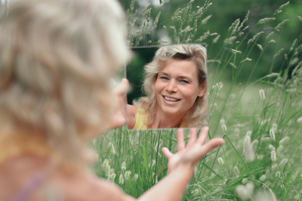 woman in green grass field during daytime