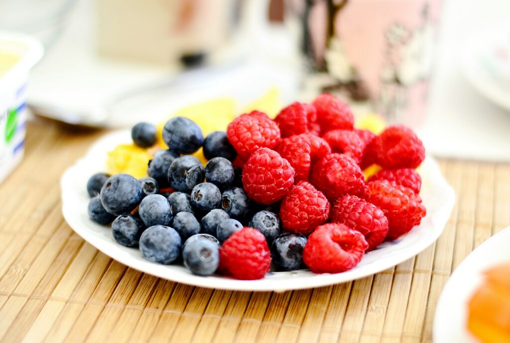 strawberries and blue berries on plate