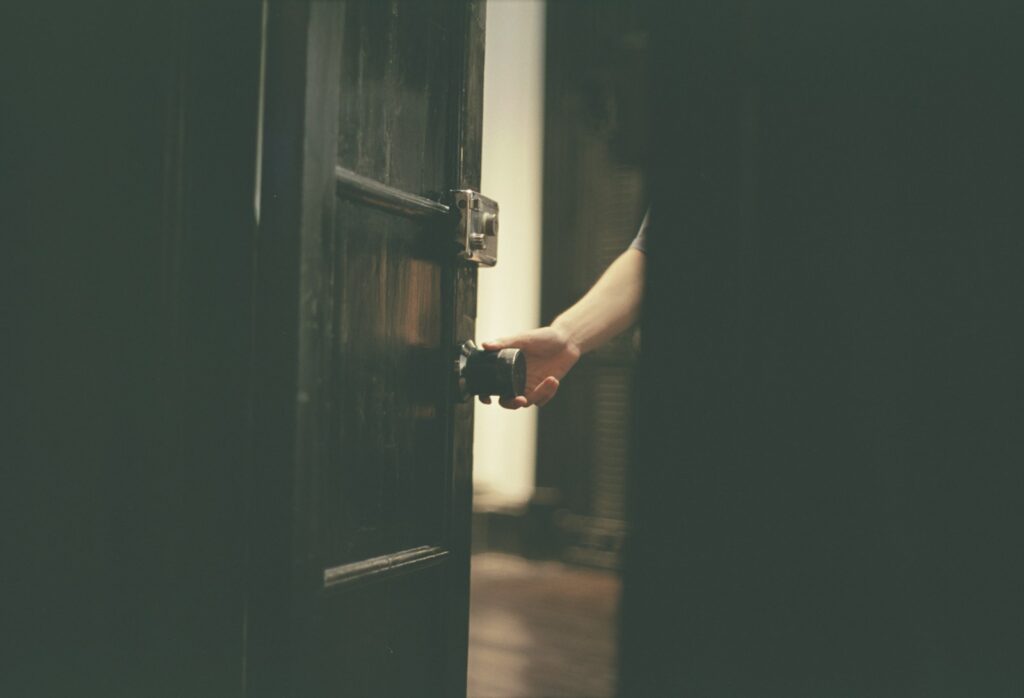 a person closing a door with their hand