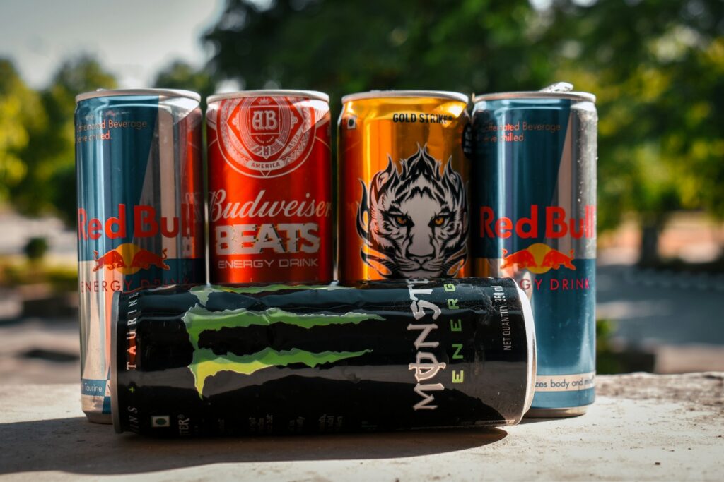 Assorted energy drink cans or soda sitting next to each other